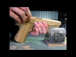 Loading the blowback rubber band gun