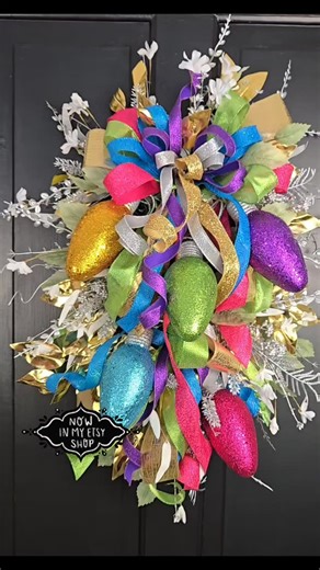 Go big or go... brighter. ✨✨ This colorful Christmas light bulb wreath is for the bold holiday hearts. The ones who still hum along to Jingle Bell Rock and think more glitter is always the answer. 🎄 It’s not just décor, it’s a celebration on your front door. 📦 Handmade, packed with sparkle, and shipping now. 🎁 Perfect for gifting or glowing up your entryway. Tag someone who LOVES color in their Christmas! 🎨👇 #ColorfulChristmas #BoldHolidayDecor #merryandbright✨ #ChristmasLights #WhimsicalWr