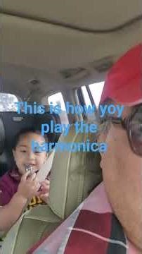 showing us how to play the harmonica