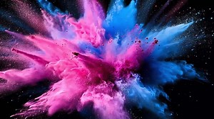 Abstract explosion of pink and blue powder on a black background.