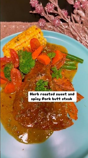 Easy herb roasted sweet and spicy pork butt steak served with garlic butter corn on a cob and veggie