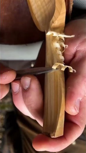 Carving a wooden spoon carefully to shape it better and make the surface smoother today by hand.