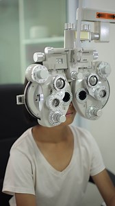 Child eye test in optical store, kid eye exam