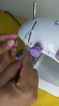 How do I thread the thread on a mini portable sewing machine?