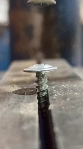 Close-Up of Screw Installation in Industrial Setting