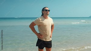 Standing confidently on beach man posing tranquil moments. Man on beach finds solace contentment in serenity of beach atmosphere allowing to be engulfed by soothing embrace of nature's beauty beach.