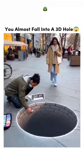 sosuua.io on Instagram: "That video is a classic example of anamorphic street art, where the artist uses forced perspective to create a 3D illusion that only looks "real" from one specific angle."