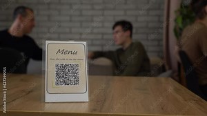 QR display with contactless digital menu on the table in the restaurant or bar. QR Ordering using QR code scanning app. Fight COVID-19