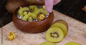 add popcorn in yogurt with kiwi flavor and chia seeds, delicious fresh yogurt with the addition of pieces of ripe yellow kiwi with chia and popcorn