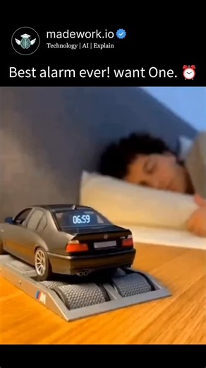 Technology | Ai | Explain on Instagram: "This viral video features a concept of a BMW M5 (E39) Alarm Clock that simulates a high-performance engine "dyno" run to wake you up. As the clock strikes 7:00 AM, the miniature silver sedan—modeled after the legendary V8-powered M5—begins revving its engine, spinning its wheels on the rollers of a scale dynamometer, and even shooting blue flames from the exhaust. The audio is a dubbed recording of a real E39 M5 engine, creating the ultimate wake-up call 
