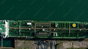 Aerial top down view oil ship tanker vessel loading in gas and oil terminal station refinery, Global trading import export logistic transport sea freight cargo tanker at port