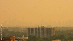 Smoke from Ontario and Quebec burning wildfires creates hazy air and sun. Fire and heavy smoke plume causes environmental disaster, intense smoke and poor air quality and visibility.