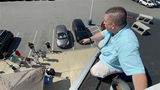 He's camping on the roof of a Subaru dealership and isn't coming down until he raises $85,000