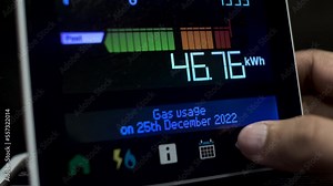 Close Up Of Finger Pressing Touchscreen Display Of UK Energy Smart Meter To Check Daily Kilowatt-hour Gas Usage For Month Of December 2022. Locked Off