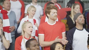 Sports crowd expressing disappointment, watching live match in stadium