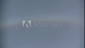 Natural sky background with moving clouds Cirrostratus and arc of halo - timelapse. Topics: optical phenomenon, weather, meteorology, atmosphere, climate, sun energy, natural colors