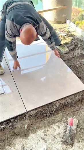 smoothing ground leveling mortar for ceramic base and installing floor tiles on balcony precision