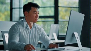 Thoughtful asian korean chinese ceo businessman dreamer smart japanese man guy sit at office desk planning business plan think idea in mind create strategy startup project use computer online work
