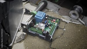 An electric automatic gate control board during repairs.