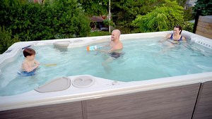 Want a place where your kids will want to play all day? The Hydropool swim spa is a year-round activity center for half the price of an underground pool. Ready to shop yours? The Water Is Calling ?? https://hubs.li/Q03dXjlH0 #wateriscalling #hydropool #swimspa #pool #backyard #familytime | Hydropool Hot Tubs and Swim Spas