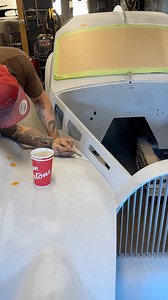 This shortcut is one we’ve developed over time, and it’s saved us hours of labor, product, and thousands of dollars. Instead of applying two-part putty over the entire car like most people do after bodywork, we’re skipping that step completely. We’re using high-build primer to fill only the spots that need it, refining the surface with precision rather than coating the whole thing. Right now, the car looks like it has chicken pox, but trust us, this method works. All those little tape marks on t