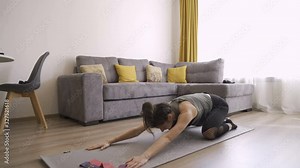 Slim and Fit woman doing yoga poses. Cobra pose and Child pose yoga poses practice