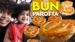 Bun Parotta is very famous in Madurai. It's my favorite too. So I wanted to try his at home. My mom helped me in this whole process of doing Bun Parotta. Ingredients: Maida Milk Egg Sugar Salt Recipe: For three bowls of maida, you will need three eggs, one bowl of milk, three tablespoons of sugar, and salt as per taste. Add a maida in a bowl, add sugar and salt in it. Mix it well. Add the eggs and milk and knead it well. Rest it for two hours. Make small balls and rest it for 15 minutes. After t