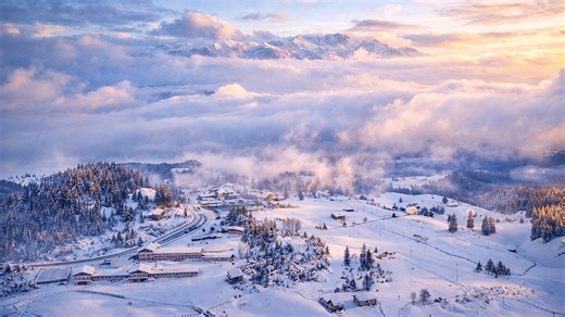A small village surrounded by snow and mountains