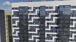 Modern residential complex offers skyscrapers with panoramic windows. Tall buildings with contemporary geometric patterns for residents
