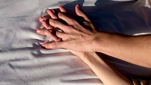 Two hands together. Concept of human relation, community, togetherness, teamwork, love, symbolism, culture and history. Hand of male and female reaching to each other