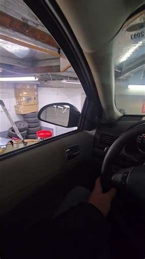 Chilling in a Chevy Cobalt on a two-post