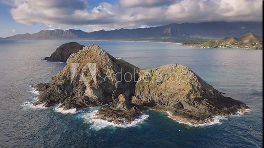 Untouched Hawaii nature. Aerial shot above rocky Na Mokulua islands on windward coast of Oahu island. Hawaii tourism background on drone camera. Scenic nature landscape for outdoors adventure travel
