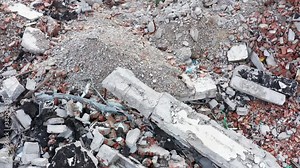 Rubble on the demolition site of a house. Pile of debris from the destruction of a building. Waste and fragments of concrete, brick and stone.
