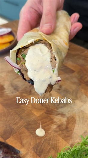 Bobby Parrish on Instagram: "Viral Doner Kebab🌯 Recipe below👇 Ingredients: 28 ounces ground beef 1 medium onion, grated 2 tablespoons Primal Kitchen Ranch Dressing 2 tablespoons greek yogurt 1 teaspoon garlic powder 1 teaspoon of cumin 1 teaspoon of paprika ¾ teaspoon salt Few cracks of pepper Wrap: Tortillas Onions Tomatoes Primal Kitchen Ranch Dressing Parsley Directions: Preheat your oven to 400°F. Grate the onion using a hand grater on the small side, or pulse it in a food processor til it