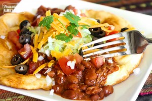 Navajo Tacos are easy to make and fun to eat! Pillowy fry bread piled with chili, cheese and your favorite toppings. https://www.favfamilyrecipes.com/tasty-navajo-tacos/ | Favorite Family Recipes