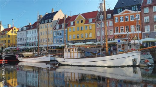 Nyhavn Harbor in Copenhagen. Famous tourist spot in Denmark with colorful historical buildings and boats on Nyhavn waterfront. Traveling in Scandinavian country