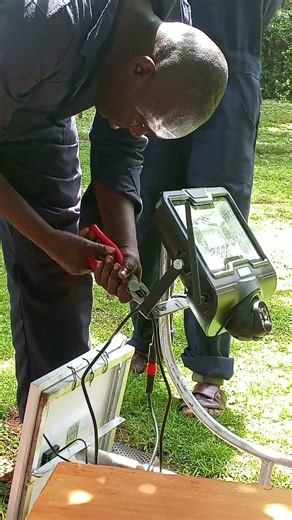 Pole mounting solar floodlight with CCTV camera installation in progress
