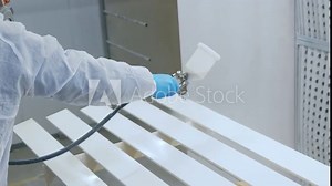 worker using spray gun and painting wood. Application of flame retardant ensuring fire protection, airless spraying. High quality 4k footage