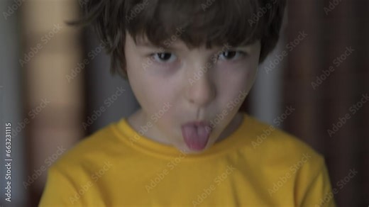 Angry Boy Shows Her Tongue in Funny Grimace. Little Boy Grimacing And Sticking Out Tongue. Close-up Portrait of Emotional Child Sticking Out His Tongue And Showing Grimaces. Kid Sticking Out Tongue.