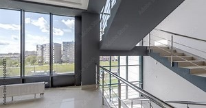 loop rotation and panoramic view in empty modern hall with stairs, columns, doors and panoramic windows overlooking the city.