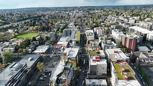 Cinematic drone footage of the University of Washington, University District with surrounding commercial and residential area near I-5 freeway in Seattle Washington