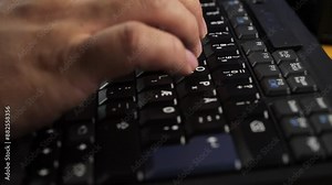 Man Typing and Working On Laptop Computer. Closeup of hands typing/working on a laptop computer keyboard with black keys