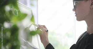 Female executive holding file and doing calculation on office whiteboard