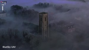 Drone captures church spire piercing 'radiation fog' covering village
