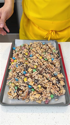 Easy holiday treat everyone will love I make a tasty christmas crack recipe with white chocolate, M&M's, and chex mix | Brian L