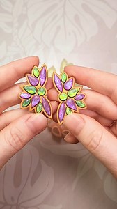 Create an embedded faux gem look with this Vivienne polymer clay cutter set. This shape was inspired by festival jewelry that might be worn to celebrate Mardi Gras. This cutter set comes with three cutters: a mirrored pair of cutters to make the overall indented shape and a separate cutter to cut out the matching gem pieces. There are two sizes available, 4 and 5 cm. When creating this design, we found it easiest to cut out the gem pieces on a tile and bake them right on the tile, without liftin