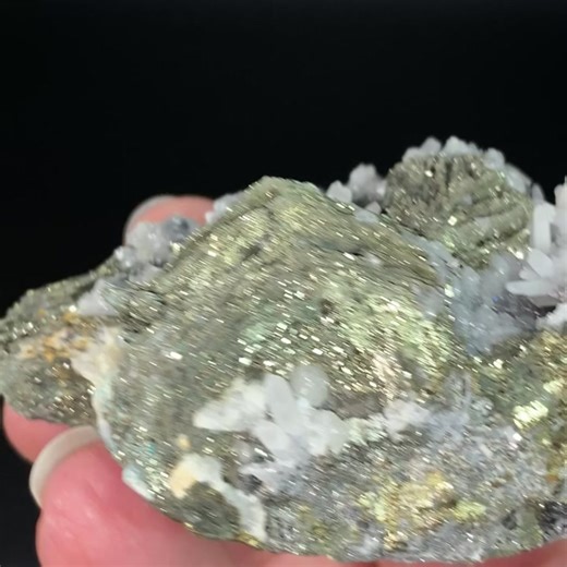 Pyrite after pyrrhotite, with boulangerite, quartz, and calcite, from Trepca Mine Complex, Mitrovica, Kosovo.The calcite fluoresces orange with 365nm long wave UV light.Pyrite after pyrrhotite (psuedomorph). This specimen has druzy pyrite replacing the original platy or sheet-like pyrrhotite crystals. The druzy pyrite sparkles brightly in any light.Size: 76 x 48 x 35 mm. 168 grams.Pyrite after pyrrhotite pseudomorph is a mineral specimen that shows the replacement of pyrrhotite by pyrite, preser