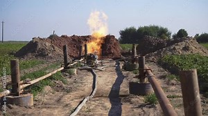 Front view of burning gas in enterprise outdoors. Footage of fire and tubes. Gas processing plant. Production of gas out of town. Delivery, technology, equipment