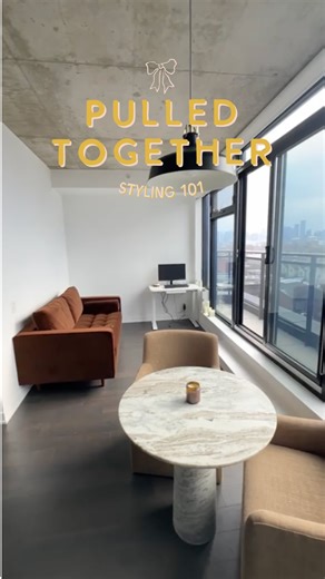 alexandra gater on Instagram: "Welcome back to Pulled Together - Styling 101! in part 2 of April’s condo transformation, I styled the living + dining room - and it’s really giving Nonna chic in here, if I do say so myself 🍷This space features the comfiest and cutest loveseat ever, a faux olive tree that had me fooled, vintage touches, and smart small-space solutions (hi projector movie nights!!) I loved pulling this space together for my best friend. it’s now cozy and full of personality, only 