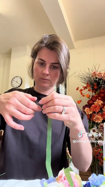 Here’s how to make a faux button hole 🌸 These are such a gorgeous edition for mums at a wedding - the same method can be used for men’s button holes, just with less flowers. You need: Floristry wire Stem tape Pot tape Faux flowers - I used one large pink rose, 3 small white roses, 3 eucalyptus leaves and some larkspur We also make these to order 🌸 #weddingflowers #fauxflowers #diywedding #buttonhole #corsage #florist #buttonholetutorial